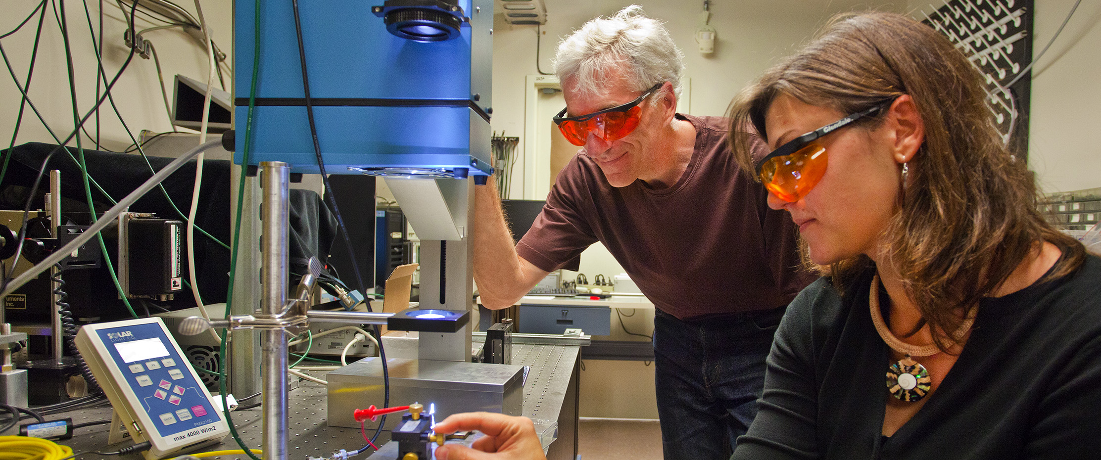 Two scientists work on a solar cell